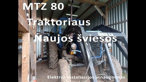 detalus daugiafunkcinės traktoriaus priekabos vaizdas, demonstruojantis jos tvirtą konstrukciją ir funkcinius elementus