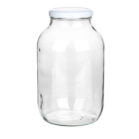 Skaidrus stiklainis su pupelės daigu, rodantis besivystančias šaknis ir stiebą.